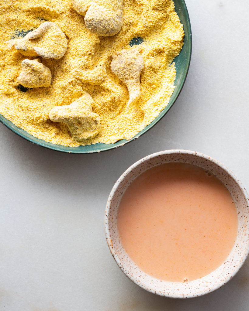 mushrooms tossed in cornmeal and milk with hot sauce on the side