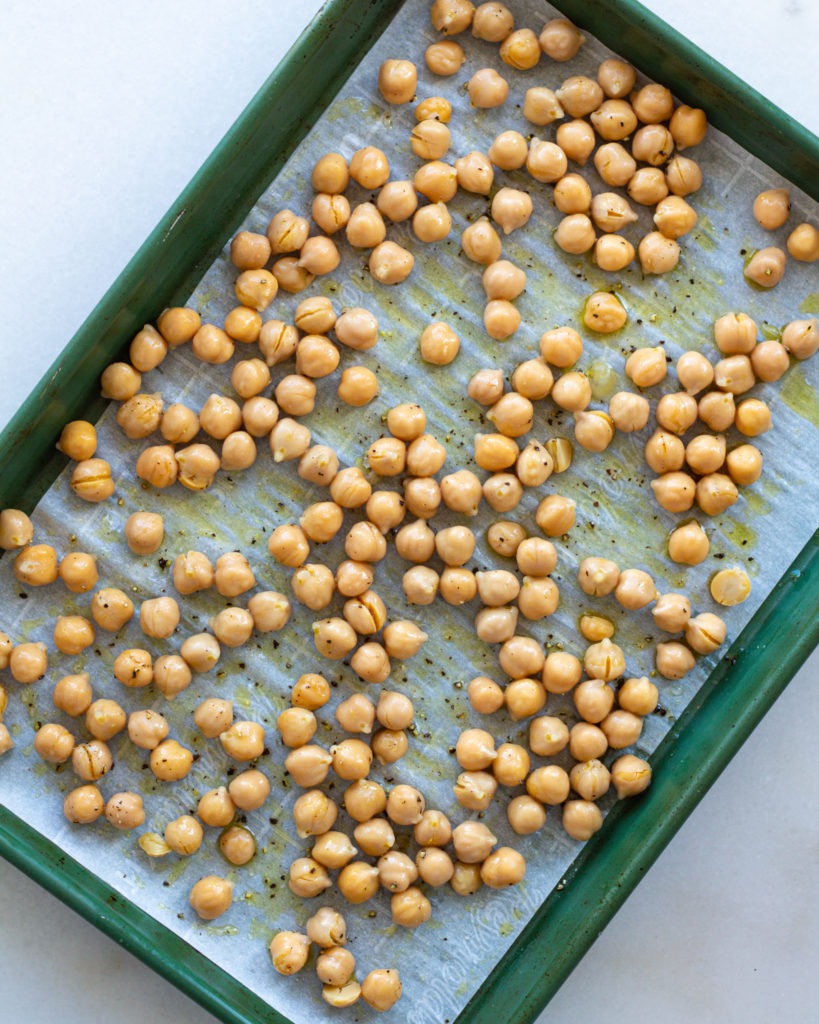 Chickpeas with olive oil on baking sheet