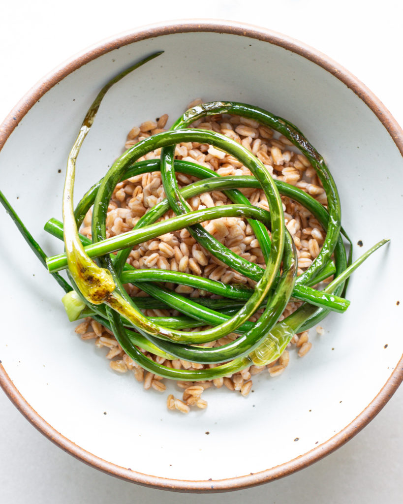 Farro and garlic scapes in bowl