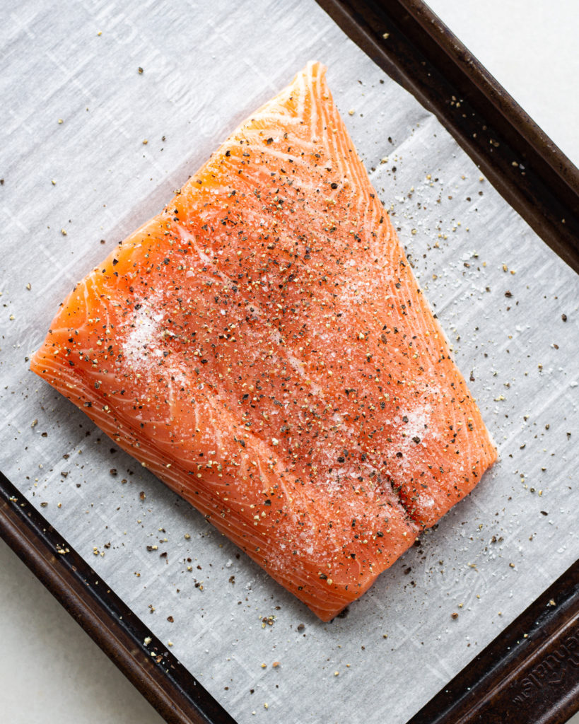 Fresh salmon, seasoned on baking sheet 