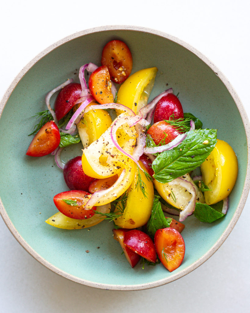 Tomatoes, herbs and onions in bowl
