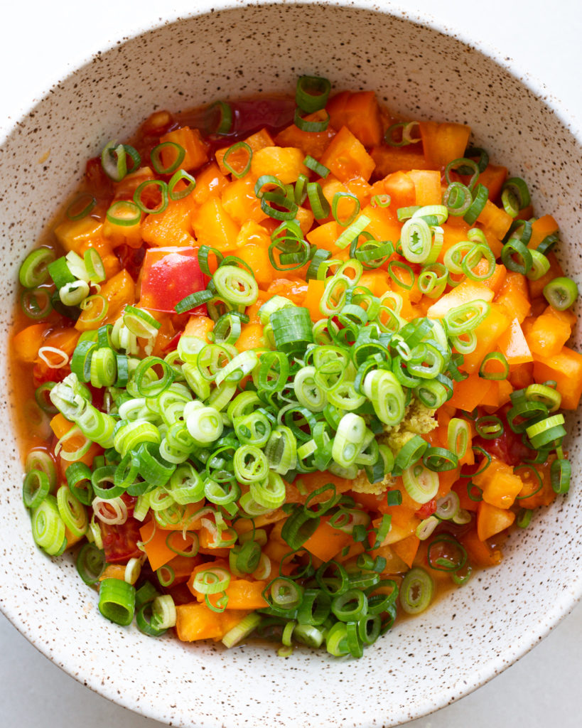 Diced tomatoes with chopped scallions in vinegar