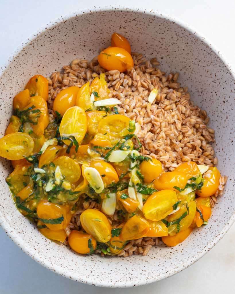 Cooked tomatoes, garlic and basil added to cooked farro
