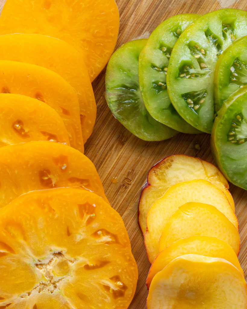 Sliced tomatoes and peaches