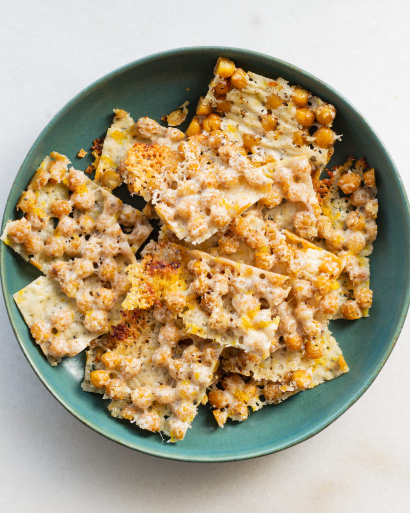 Lemon parmesan chickpea crisps in a green bowl. 