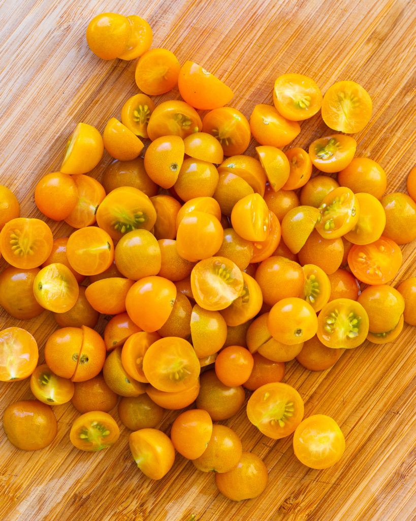 Sliced Sungold tomatoes