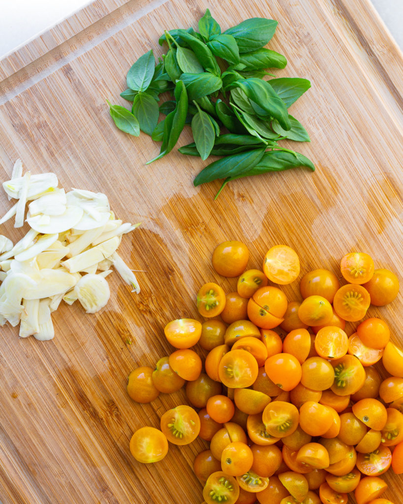 Sliced garlic, Sungold tomatoes, and fresh basil