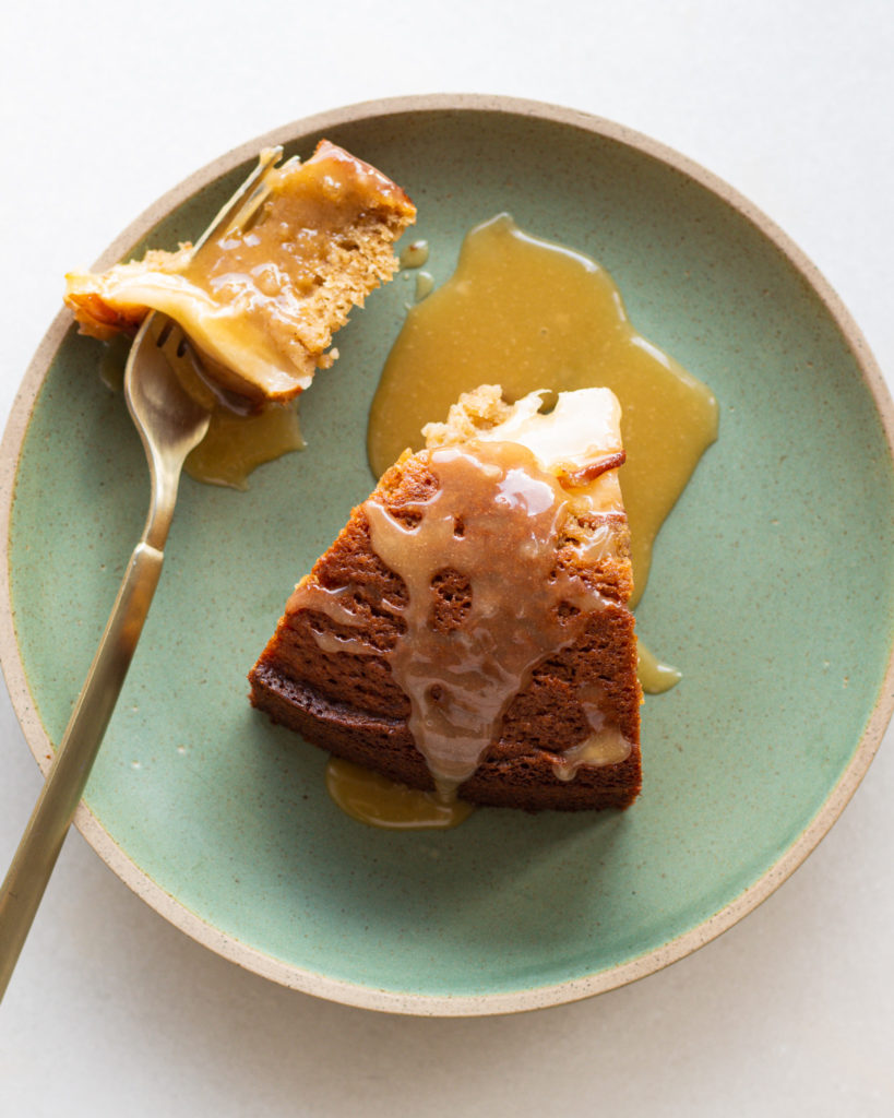 Slice of pear ginger cake with caramel drizzle