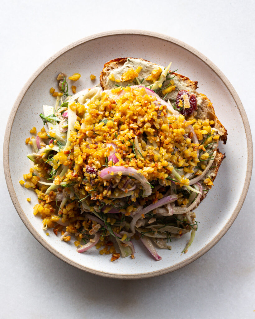 Image of fennel salad with tempeh on toast. 
