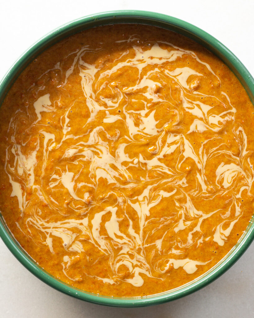cake batter with tahini swirl in a round baking dish