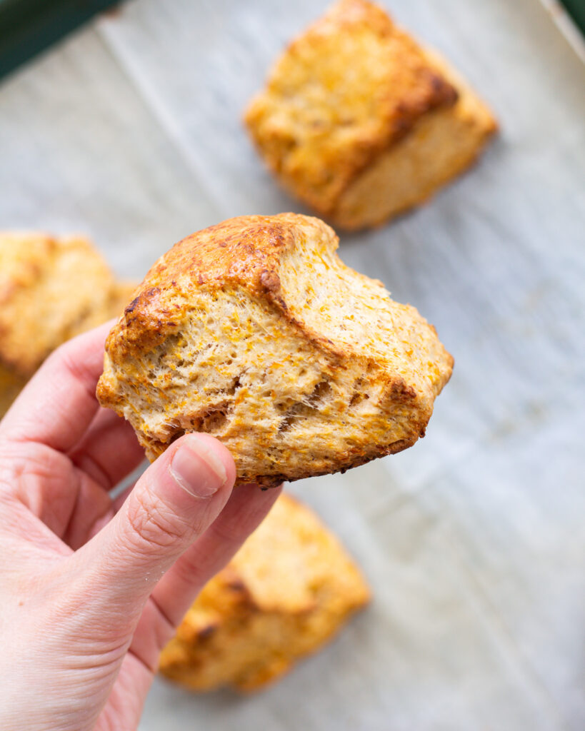 closeup of finished carrot butter biscuit, with other biscuits in the background