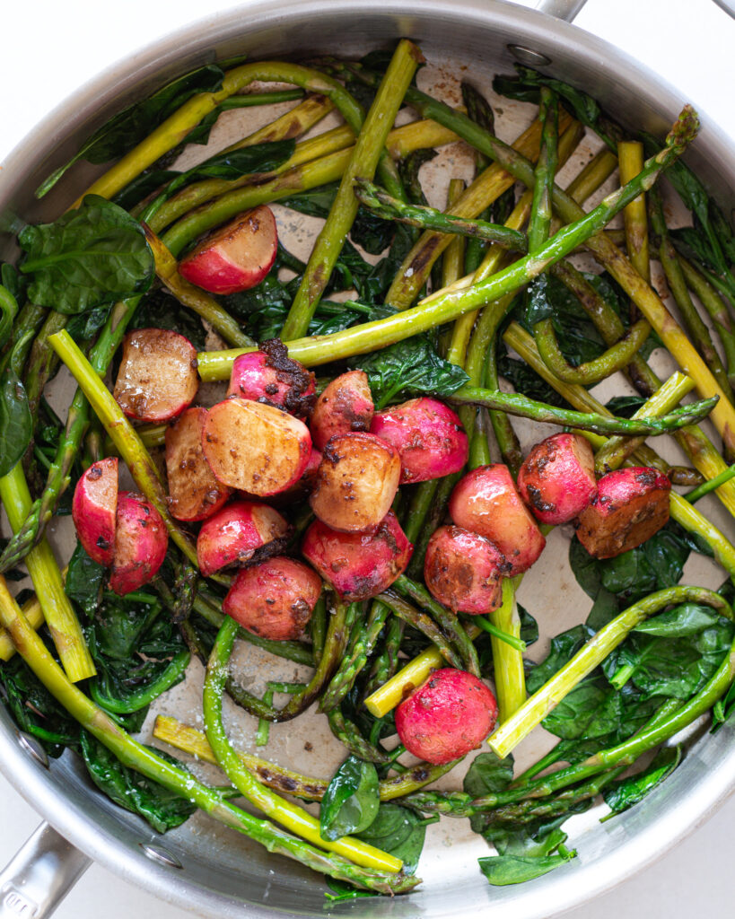 charred radishes and asparagus in a pan