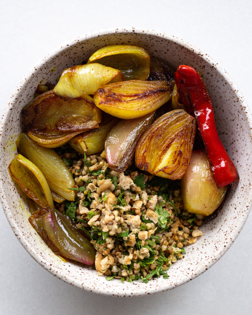 Turmeric shallots with crispy buckwheat and beans in a bowl
