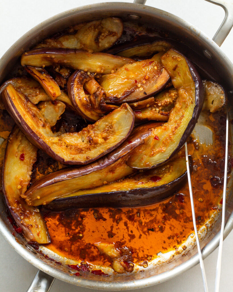 Calabrian chili butter and eggplant cooking in pan