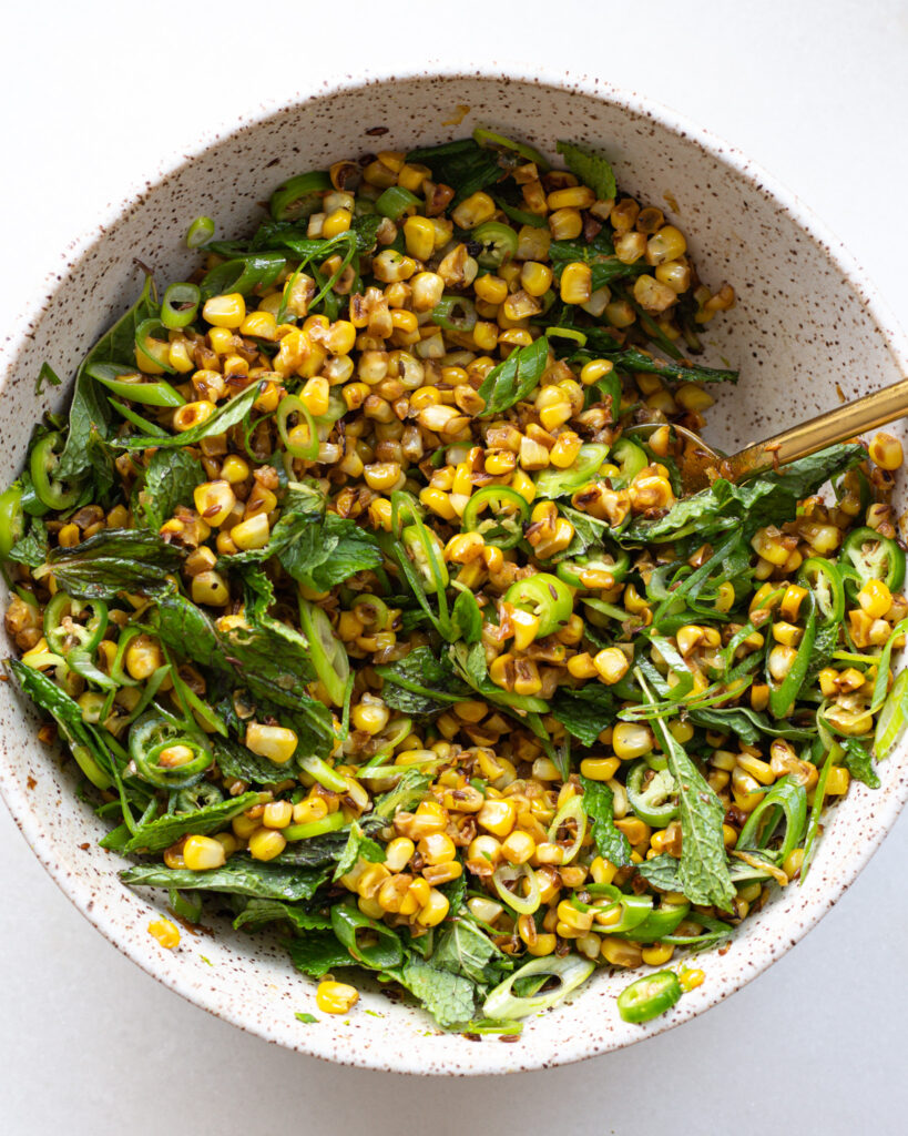 Cumin corn with mint, sliced peppers, mint, and green onion