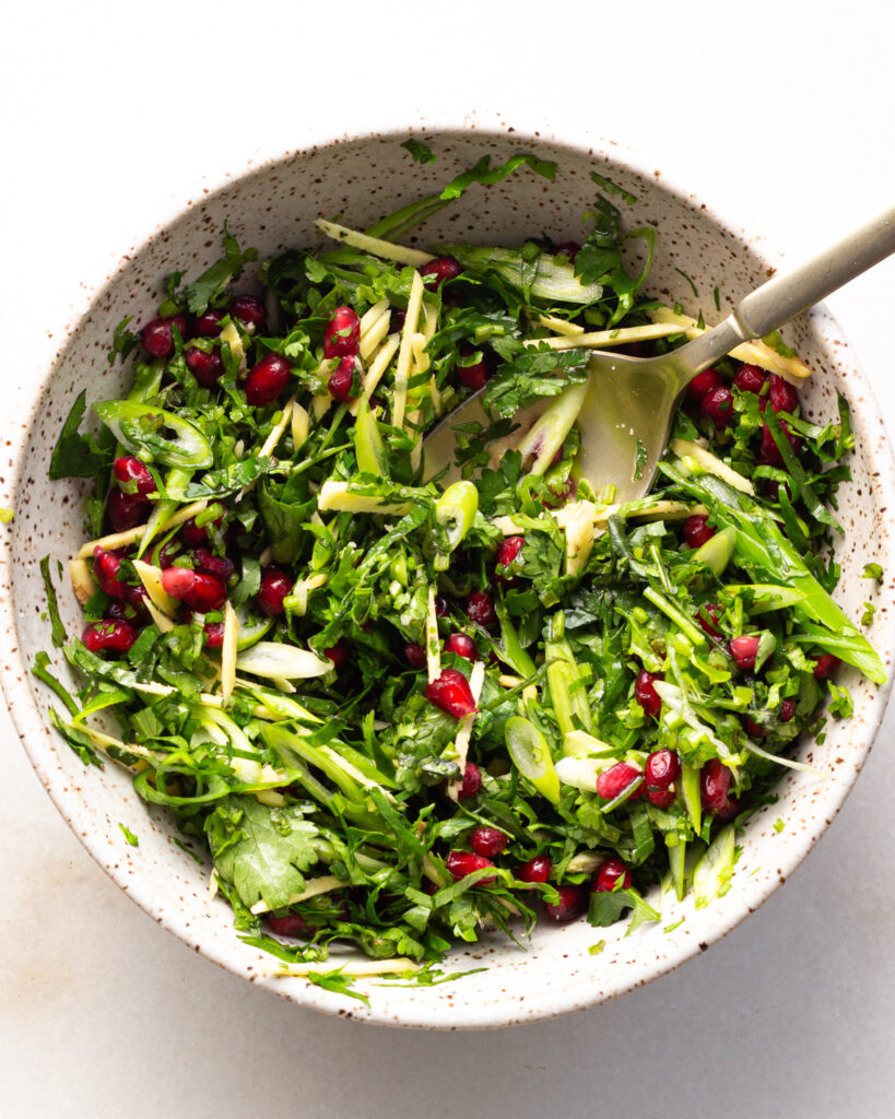 greens salad with pomegranate seeds