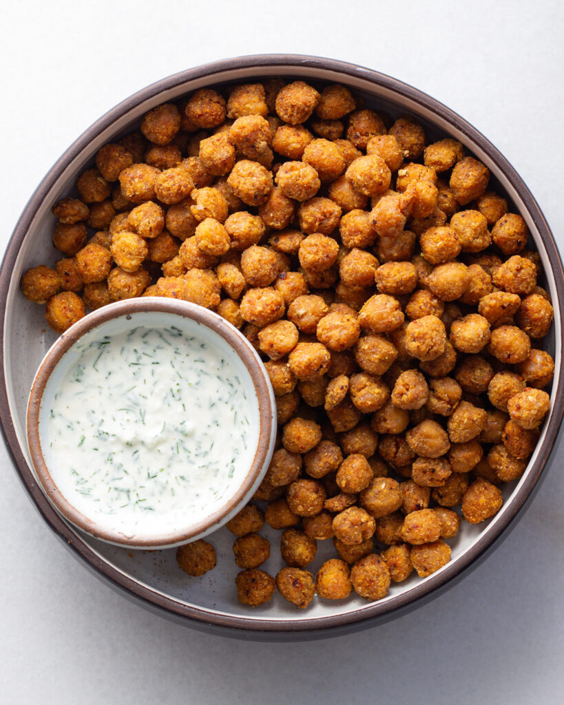 Breaded chickpeas in a bowl with lemon dill dip.