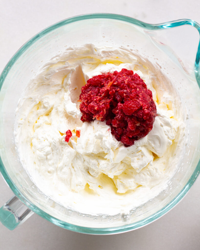 raspberries added to whipped cream