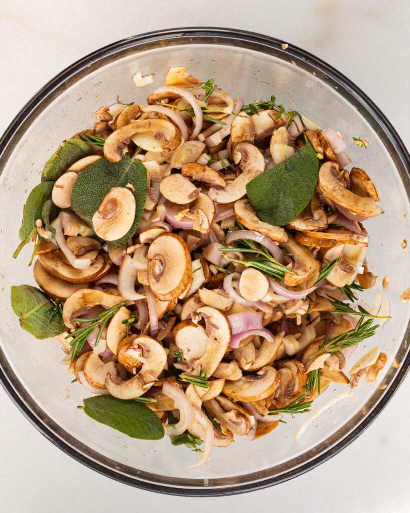 seasoned herbs, shallots, mushrooms and other ingredients in bowl