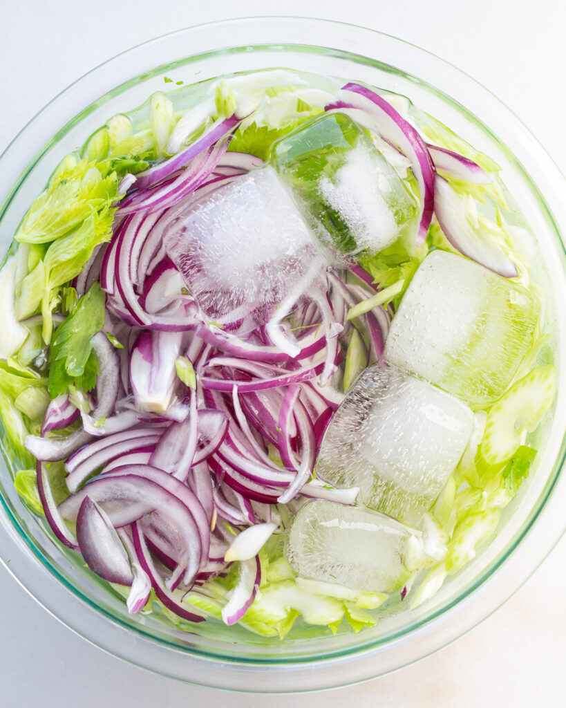 red onion and celery soaking in ice water