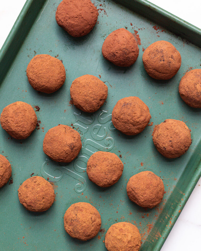 Pumpkin spice brownie bites rolled in cocoa powder