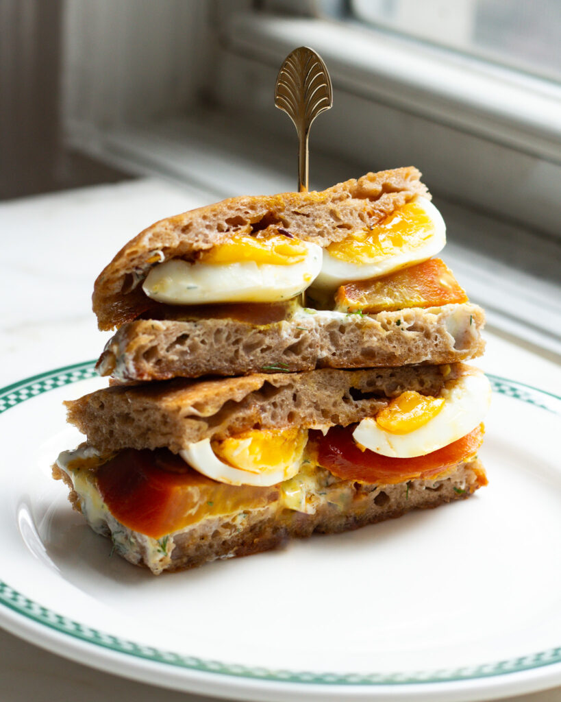 Two halves of a çilbir sandwich stacked on top of each other