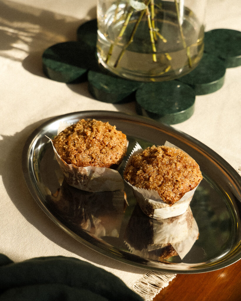 Two carrot muffins on a tray