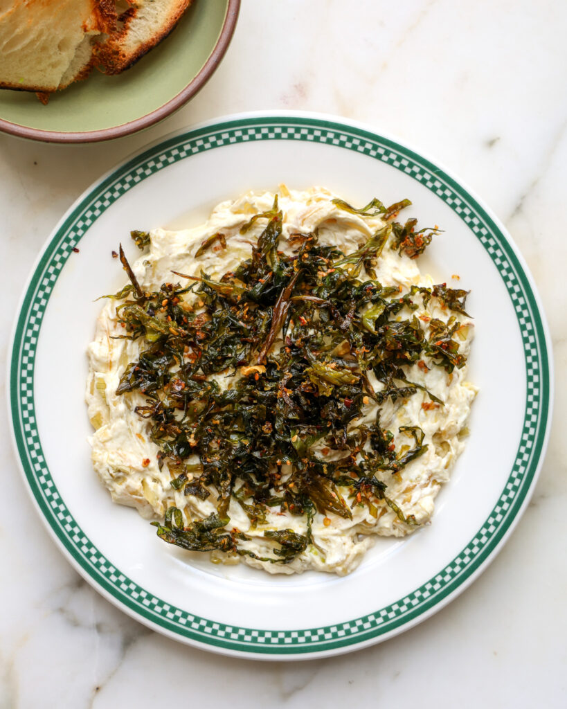 spring onion dip on a plate with bread