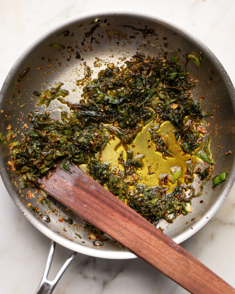 fried spring onion greens in a pan 