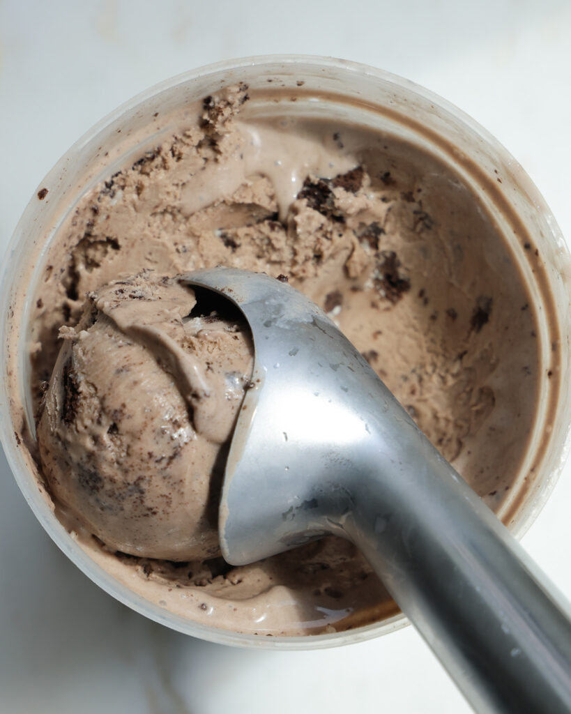 oreo infused ice cream being scooped out
