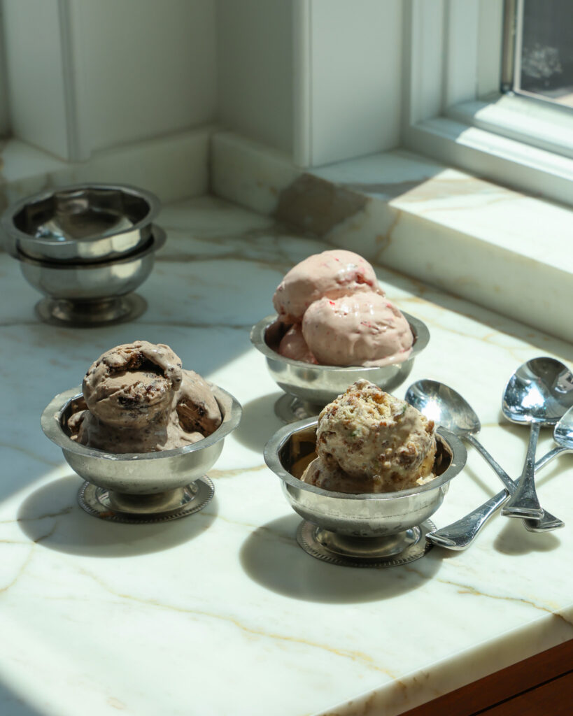 ice cream cups filled with oreo ice cream, strawberry ice cream, and cookie ice cream 