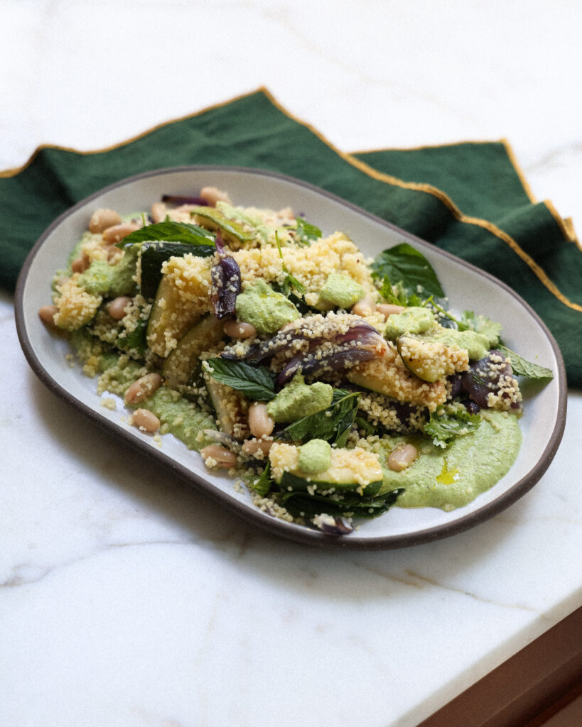 green romesco couscous salad on a plate 