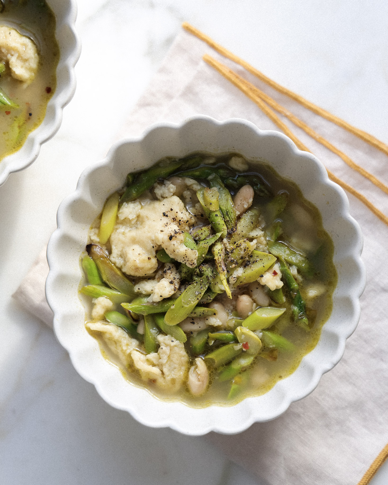 Lemon asparagus spaetzle topped with black pepper.
