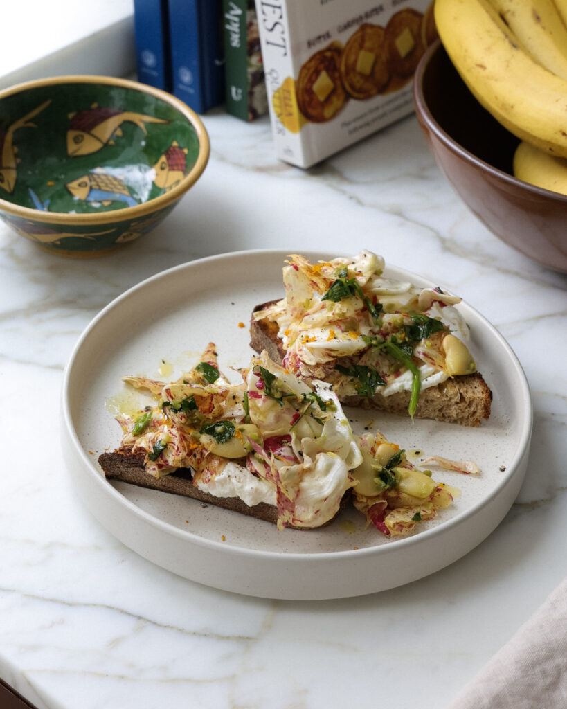 ingredients for chicory salad on top of ricotta toast