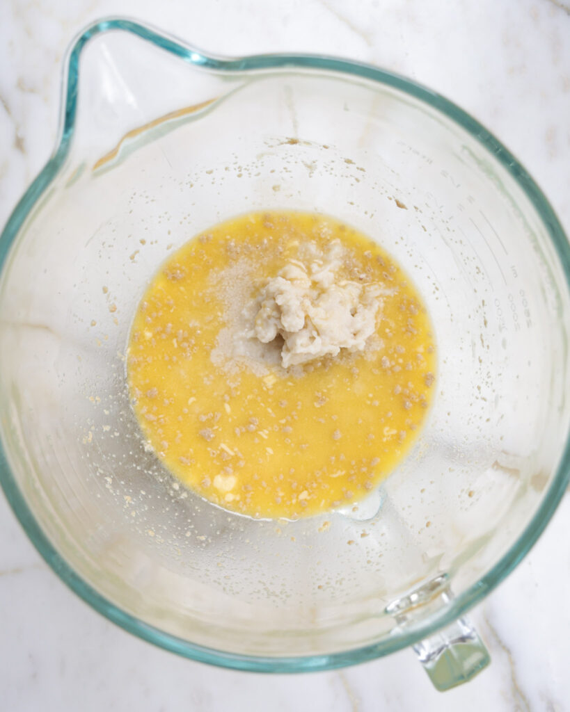 wet ingredients and yeast in a mixing bowl.