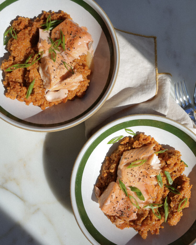 gochujang baked quinoa topped with salmon and scallions.