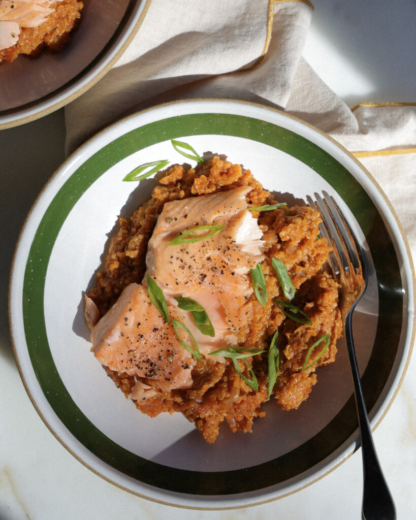 gochujang baked quinoa topped with salmon and scallions.