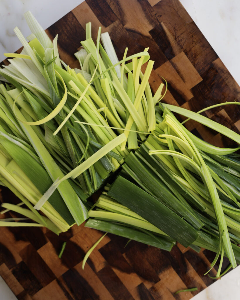 Leek greens on a cutting board.