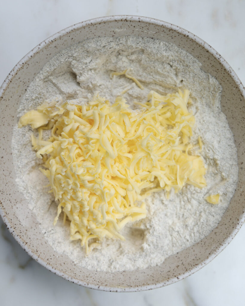 butter added to a bowl of flour.