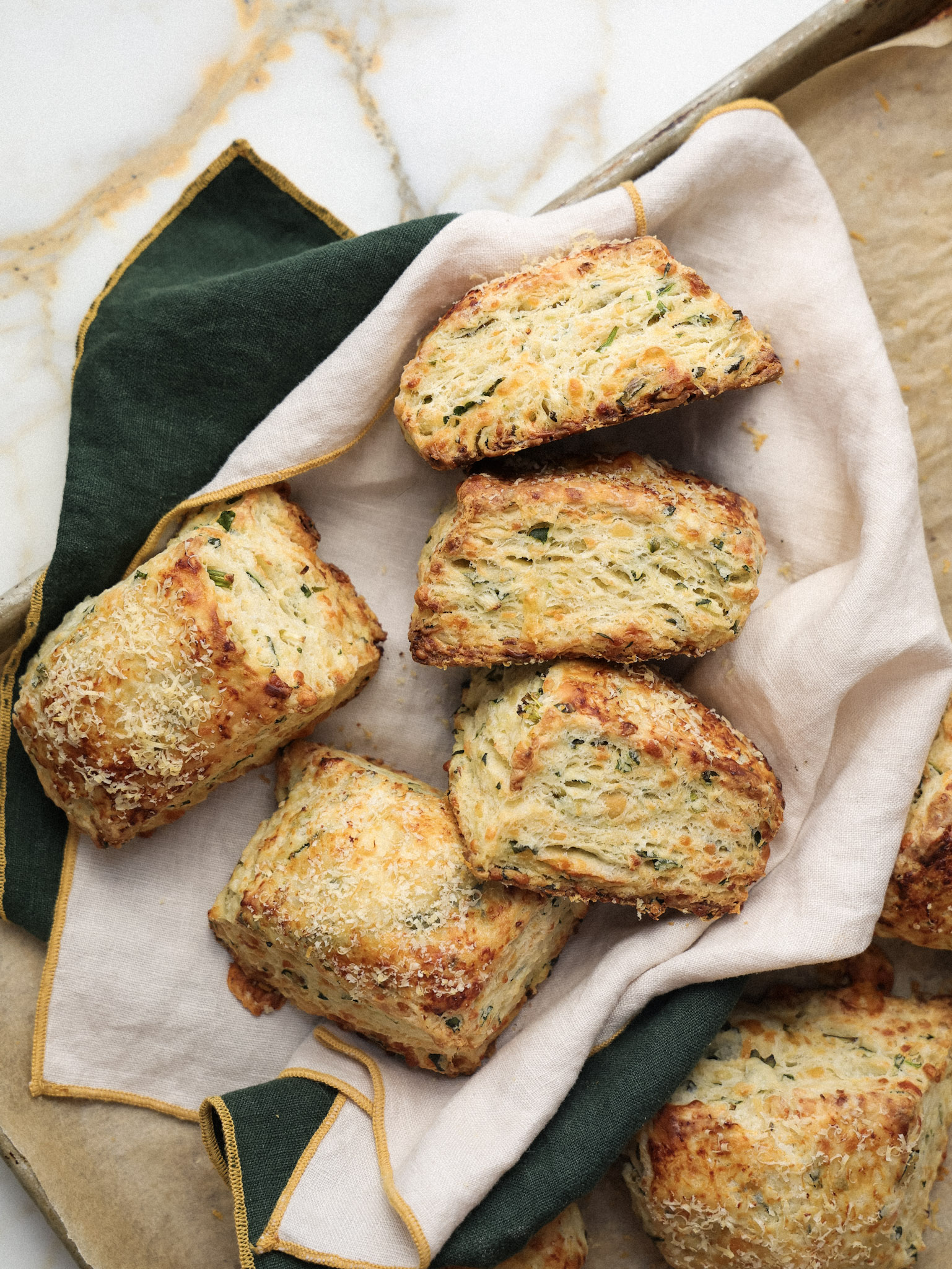 three cheese ramp biscuits nestled onto a tea towel.