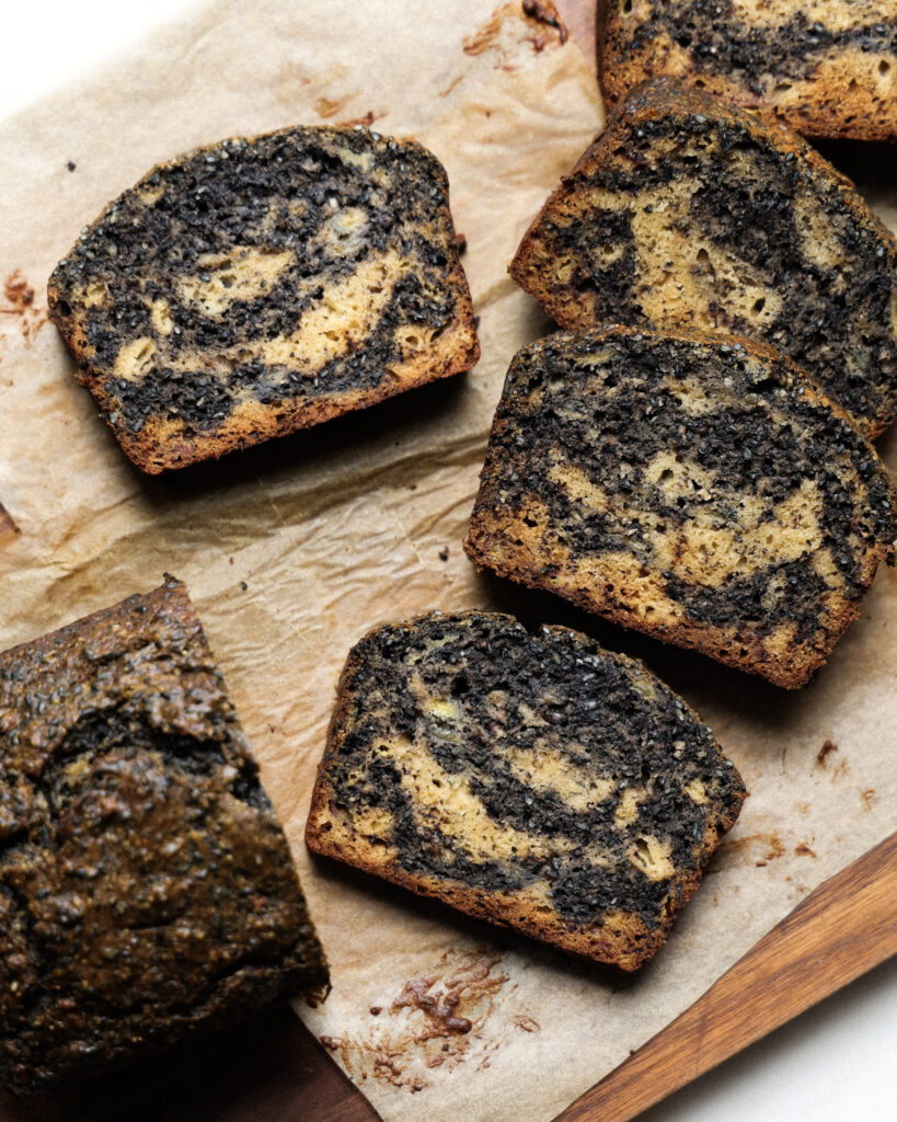 sliced black sesame banana bread on a cutting board.