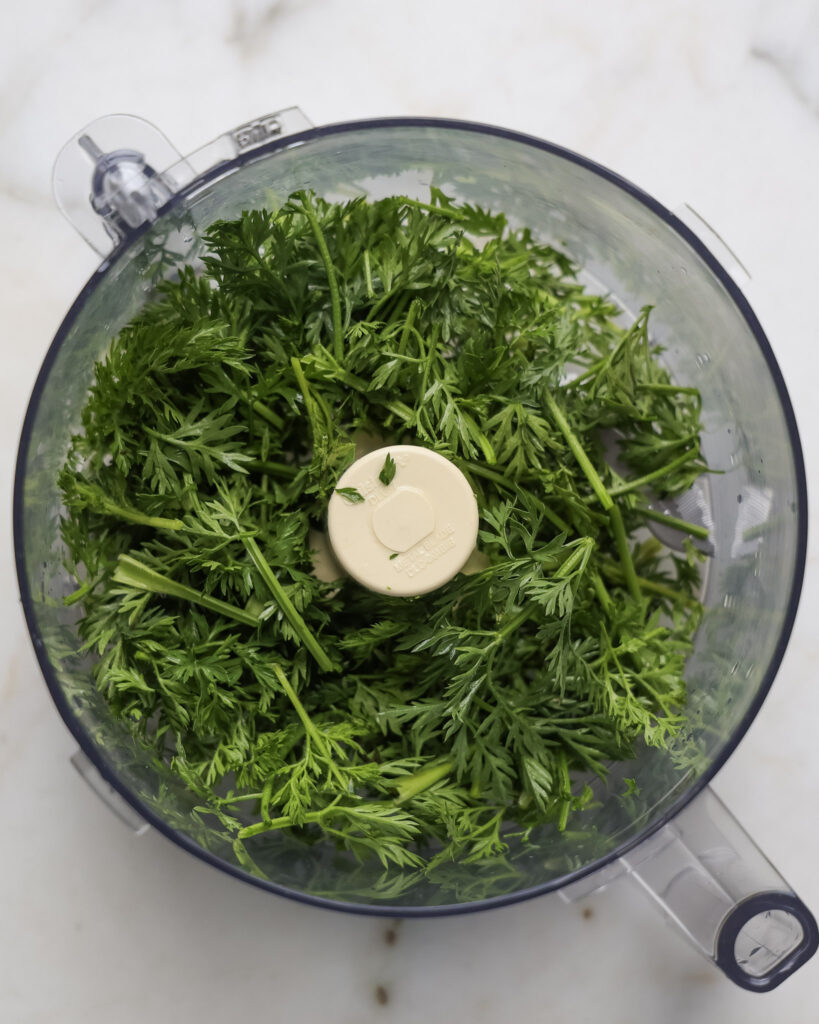 Carrot tops in a food processor.