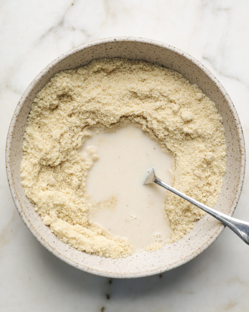 ingredients for edible sugar cookie dough being mixed in a bowl.