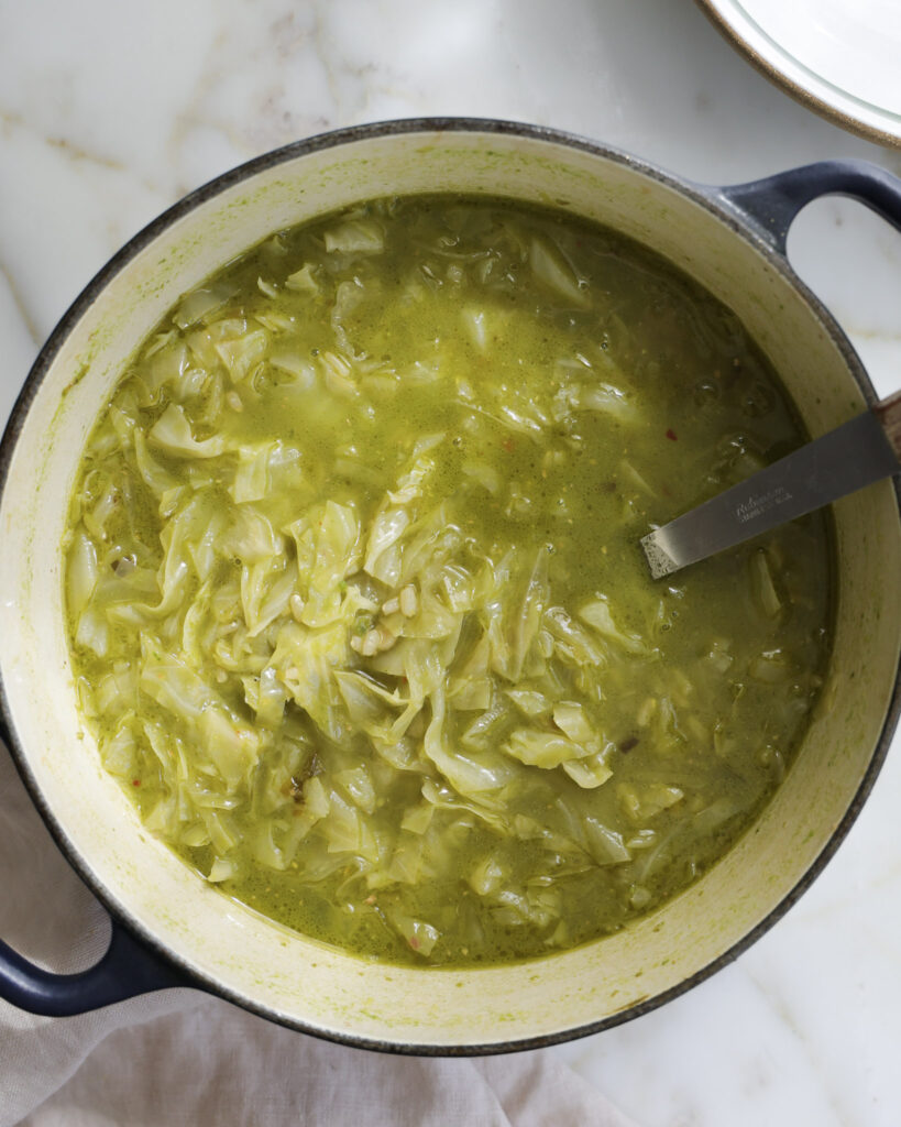 green cabbage and ramp soup in a Dutch oven.