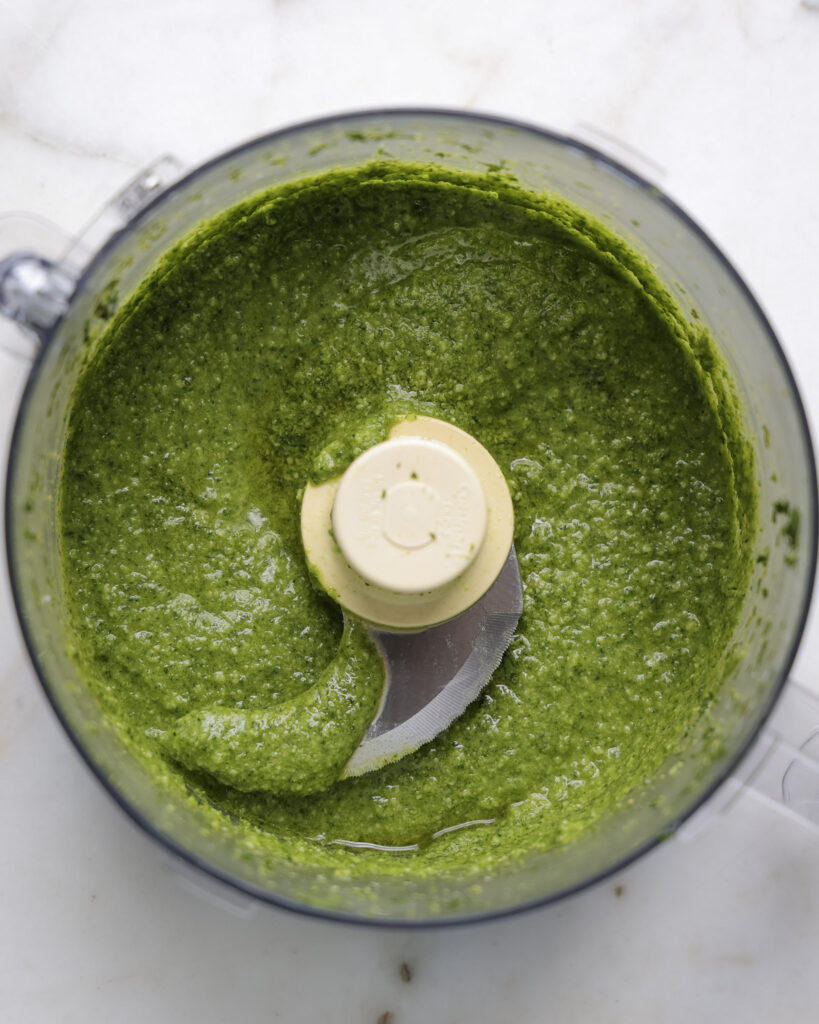 Carrot top pesto in food processor.