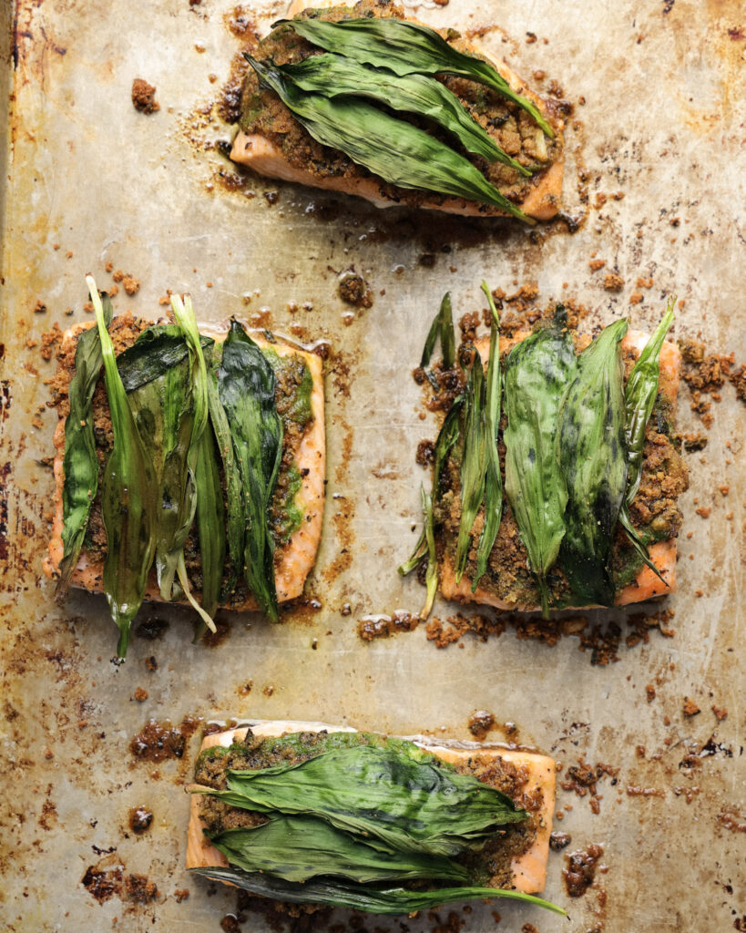 ramp wrapped salmon on a baking sheet.