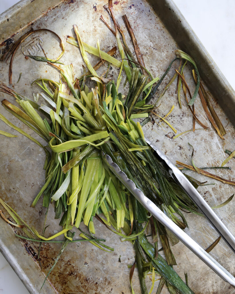 roasted leek greens on a baking sheet.