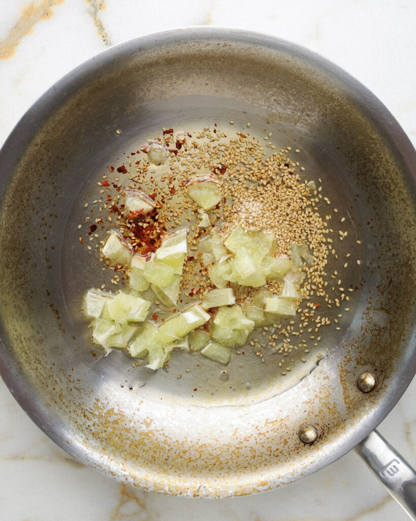 Lime, sesame seeds, aleppo pepper in a pan.