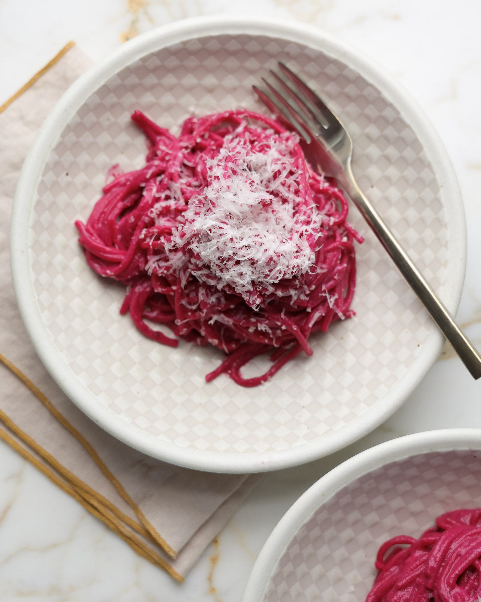 Beet Pasta topped with parmesan.