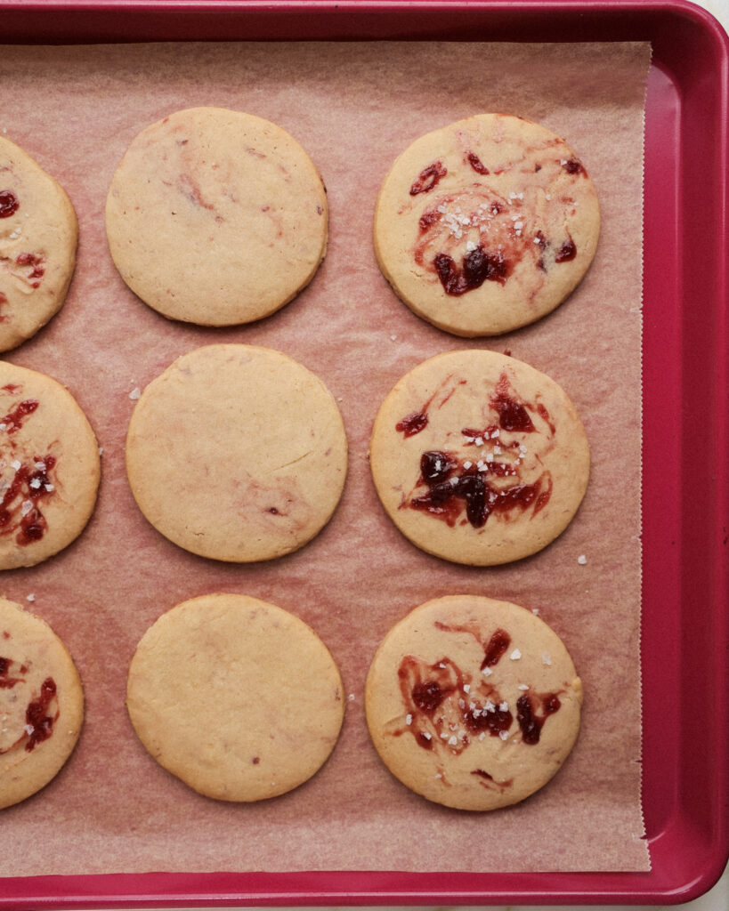 Baked cookies with jam swirled on top.